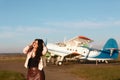 Girl posing near aircraft, Traveler woman plan and backpack see the airplane at the airport glass window, girl tourist hold bag an Royalty Free Stock Photo