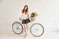 Girl posing next to her old retro bicycle