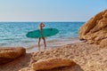 Girl posing with surfboard on coastline. Hot summer day on beach. Summer time, surf sport and vacation idea, copy space Royalty Free Stock Photo