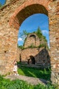 Girl posing in technical ruin. Iron Smelting Plant called Frantiskova Huta in Slovakia