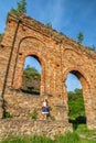 Girl posing in technical ruin. Iron Smelting Plant called Frantiskova Huta in Slovakia