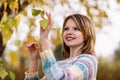 Girl posing under foliage in autumn season Royalty Free Stock Photo