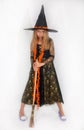 Girl posing in witch dress, Halloween