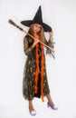 Girl posing in witch dress, Halloween