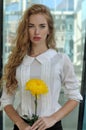 Girl posing with a yellow flower Royalty Free Stock Photo