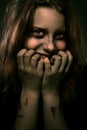 Girl possessed by a demon with a sinister smile Royalty Free Stock Photo