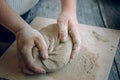 Girl the Potter kneads the clay.