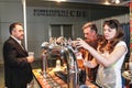 Girl pouring beer to glass from beer tap