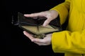 Girl pouring coins out of a purse, black background, close-up, coin Royalty Free Stock Photo