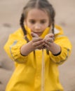 Girl pouring sand from hands Royalty Free Stock Photo