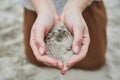 Girl pouring sand out of her hands. Royalty Free Stock Photo