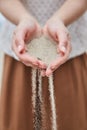 Girl pouring sand out of her hands. Royalty Free Stock Photo