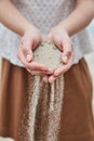 Girl pouring sand out of her hands. Royalty Free Stock Photo