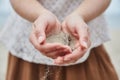 Girl pouring sand out of her hands. Royalty Free Stock Photo