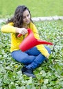 Girl pouring small tree with a bucket