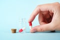 Girl pours the last pills into her palm on a light background close-up. vitamins. pharmaceuticals. chemical industry.