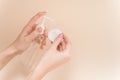 The girl pours micellar gel on a cotton pad to cleanse the skin. The girl`s hands squeeze out micellar water on a cotton pad