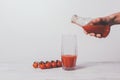 Girl pours tomato juice into a glass Royalty Free Stock Photo