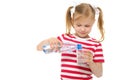 Girl pours water from bottle into glass Royalty Free Stock Photo