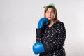 Girl power concept. Confident young woman isolated on gray wall background. Feminine and independent strength.Girl in boxing Royalty Free Stock Photo