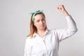 Girl power concept. Young woman showing her arm for feminine and independent strength Royalty Free Stock Photo