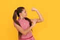 Girl power. Female child flex arm yellow background. Gesture of power and strength. CRL PWR