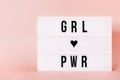 `Girl power` Luminous poster with copy space. Feminist themed letters with pink background