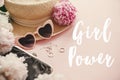 Girl Power text sign at stylish girly pink retro sunglasses, peonies, jewelry, hat, purse on pastel pink paper. Happy Women`s Day