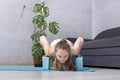 Girl practices yoga using foam blocks. Young woman doing exercise with yoga bricks. Plank pose or chaturanga dandasana Royalty Free Stock Photo