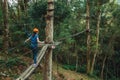 Girl practicing tree climbing in a forest