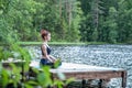 girl  practicing yoga in the nature on the lake. Female happiness. Landscape background Royalty Free Stock Photo