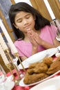 Girl praying during dinner