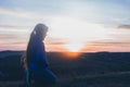 The girl is praying on her knees. On the background of the sunset sky. Repentance for sins. Kneeling Prayer to God. Worship Royalty Free Stock Photo