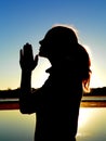 Girl Praying by Lake