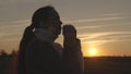 girl praying at sunset in the sky, silhouette of a woman asking for help, reading prayer in sun, living as believer Royalty Free Stock Photo