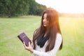 The girl looks to the Bible with the solar background Royalty Free Stock Photo