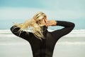 Girl, prepare and swimsuit for swimming in beach, blue sky and freedom in nature for adventure. Athlete, outdoor and Royalty Free Stock Photo