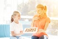 The girl prepared a surprise for her mother. Daughter gave mother a box of chocolates