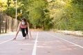 A girl prepared to run on a running track with the mask to avoid the Covid virus 19