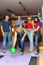 Girl prepares for throw ball, friends hearten it