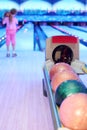 Girl prepares to throw ball in bowling Royalty Free Stock Photo