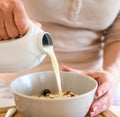 Girl preparing morning breakfast with oatmeal