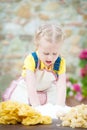 Girl preparing pasta dough on rustic wooden table in countryside