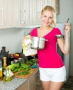 Girl preparing soup in cooking pot Royalty Free Stock Photo