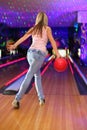 Girl preparing to throw of ball in bowling club