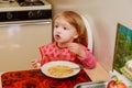 Girl-preschooler eats a tasty meal in cozy