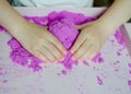 Girl preschooler sculpts kinesthetic sand