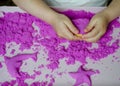 Kid`s hands with kinesthetic sand Royalty Free Stock Photo