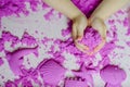 Kid`s hands with kinesthetic sand