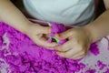 Kid`s hands with kinesthetic sand